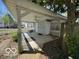 Covered back patio with white fencing at 113 1St St, Shelbyville, IN 46176