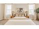 Inviting bedroom with a king-sized bed, neutral decor, and natural light from large windows at 1226 Cottage Ave, Indianapolis, IN 46203