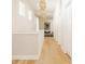 Bright hallway with light wood floors and decorative lighting leading into the living room at 1226 Cottage Ave, Indianapolis, IN 46203