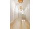 Bright hallway with hardwood floors, white doors, and stylish pendant lighting at 1226 Cottage Ave, Indianapolis, IN 46203