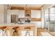 Elegant kitchen featuring white cabinets, a marble countertop island, and stainless steel appliances for a modern touch at 1226 Cottage Ave, Indianapolis, IN 46203