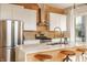 Modern kitchen featuring white cabinetry, stainless steel appliances, and a marble countertop island with barstool seating at 1226 Cottage Ave, Indianapolis, IN 46203