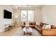 Cozy living room with a plush sectional sofa, a sleek TV, and a neutral color palette for relaxation at 1226 Cottage Ave, Indianapolis, IN 46203