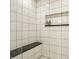 Modern shower with white tiles, a built-in bench, and a convenient storage niche at 1226 Cottage Ave, Indianapolis, IN 46203