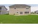 Large backyard featuring lush green grass and a patio, perfect for outdoor activities at 13204 Caterwood Cir, Fishers, IN 46037
