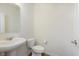Bathroom with pedestal sink, toilet, mirror, and vinyl flooring at 13204 Caterwood Cir, Fishers, IN 46037