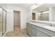 Elegant bathroom featuring gray vanity with granite countertop, tiled floors, and a glass-enclosed shower at 13204 Caterwood Cir, Fishers, IN 46037