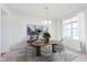 This dining room offers stylish decor, modern chandelier, and views from a bright window at 13204 Caterwood Cir, Fishers, IN 46037