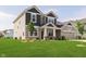 Beautiful home exterior features a lush lawn and a covered front porch at 13204 Caterwood Cir, Fishers, IN 46037
