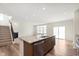 Kitchen with granite countertop island and stainless steel dishwasher open to the living area at 13204 Caterwood Cir, Fishers, IN 46037