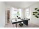 Bright office with large windows, modern desk, and unique plant decor at 13204 Caterwood Cir, Fishers, IN 46037