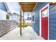 Back porch view with a wooden ceiling and posts, concrete floor and red door at 1330 Marlowe Ave, Indianapolis, IN 46202