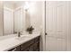 Bright bathroom featuring vanity with quartz countertop, decorative mirror, and modern finishes at 1330 Marlowe Ave, Indianapolis, IN 46202