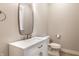 Neutral powder room with a white vanity, brushed-nickel fixtures, and a large decorative mirror at 1330 Marlowe Ave, Indianapolis, IN 46202