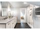 Bright bathroom featuring double sinks, granite counters and a walk-in shower at 1330 Marlowe Ave, Indianapolis, IN 46202