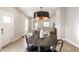 Dining room showcasing wood floors, modern light fixture and an open floorplan to a living room and kitchen at 1330 Marlowe Ave, Indianapolis, IN 46202