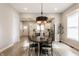 Contemporary dining room with a statement light fixture, wood floors, and an open view to the modern kitchen at 1330 Marlowe Ave, Indianapolis, IN 46202