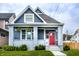 Charming home with a red door, grey painted brick porch, gray siding and well-maintained lawn at 1330 Marlowe Ave, Indianapolis, IN 46202