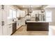 Bright kitchen featuring white cabinets, stainless steel appliances, and a dark wood island with white countertop at 1330 Marlowe Ave, Indianapolis, IN 46202