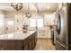 Modern kitchen with white cabinetry, stainless steel appliances, large island and stylish lighting fixtures at 1330 Marlowe Ave, Indianapolis, IN 46202