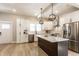 Modern kitchen features white cabinets, a center island with a marble countertop, and stainless steel appliances at 1330 Marlowe Ave, Indianapolis, IN 46202