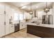 Stylish kitchen boasting white cabinetry, stainless steel appliances, and a dark wood island with a marble countertop at 1330 Marlowe Ave, Indianapolis, IN 46202