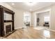 Bright living room features light wood floors, an ornate fireplace, and large openings to other rooms at 1330 Marlowe Ave, Indianapolis, IN 46202