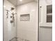 Modern shower featuring white subway tile, a niche, and bronze fixtures at 1330 Marlowe Ave, Indianapolis, IN 46202