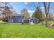 The large backyard has mature trees, and includes a playset for children at 13363 Lantern Rd, Fishers, IN 46038