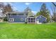 A large green lawn and screened porch provides ample space for outdoor enjoyment at 13363 Lantern Rd, Fishers, IN 46038
