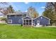 Expansive backyard features a deck and screened porch, with an adjacent patio seating area at 13363 Lantern Rd, Fishers, IN 46038