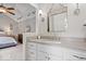 Bright bathroom boasts a white vanity, modern fixtures and stylish sliding barn door mirror to complement the bedroom design at 13363 Lantern Rd, Fishers, IN 46038