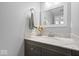 Bathroom featuring a vessel sink with stylish faucet, decorative mirror and soft gray walls at 13363 Lantern Rd, Fishers, IN 46038