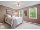 Cozy bedroom featuring natural light from two windows, ceiling fan, neutral walls, and soft bedding at 13363 Lantern Rd, Fishers, IN 46038