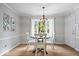 Charming dining room features a modern chandelier and a bright bay window at 13363 Lantern Rd, Fishers, IN 46038