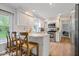 Bright kitchen with white cabinets, stainless steel appliances, and a breakfast bar at 13363 Lantern Rd, Fishers, IN 46038