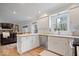 Open-concept kitchen with white cabinets, stainless steel appliances, and an island counter at 13363 Lantern Rd, Fishers, IN 46038
