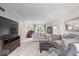 Comfortable living room featuring neutral tones, plush seating, and large windows at 13363 Lantern Rd, Fishers, IN 46038