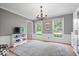 Cozy living room featuring natural light, neutral paint colors and white wainscoting at 13363 Lantern Rd, Fishers, IN 46038