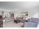 Comfortable living room featuring neutral tones, plush seating, and large windows at 13363 Lantern Rd, Fishers, IN 46038