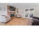 Comfortable living room with fireplace, built-ins, and a view to the backyard through French doors at 13363 Lantern Rd, Fishers, IN 46038