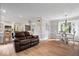 Open-concept living space with modern kitchen, cozy dining area, and plush leather sofa at 13363 Lantern Rd, Fishers, IN 46038