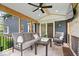 Relaxing porch offers a fireplace, comfortable seating, fan, and outdoor views at 13363 Lantern Rd, Fishers, IN 46038