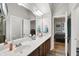 Bathroom featuring double sinks, wood cabinetry, and open doorway at 1404 Rosebank Dr, Westfield, IN 46074