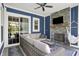 Covered patio featuring a stone fireplace, tv, outdoor sofa, and a hanging hammock chair at 1404 Rosebank Dr, Westfield, IN 46074