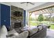Covered patio with stone fireplace, hanging hammock chair, sofa, and backyard views at 1404 Rosebank Dr, Westfield, IN 46074