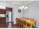 Bright dining area featuring a wooden table, chairs, and stainless steel refrigerator at 1404 Rosebank Dr, Westfield, IN 46074