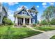 Charming two-story home with a blue exterior, inviting front porch, and well-manicured lawn at 1404 Rosebank Dr, Westfield, IN 46074