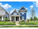 Charming two-story home with a blue exterior, inviting front porch, and well-manicured lawn at 1404 Rosebank Dr, Westfield, IN 46074