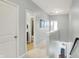 Hallway view to staircase, bathroom, art work and bedroom at 1404 Rosebank Dr, Westfield, IN 46074